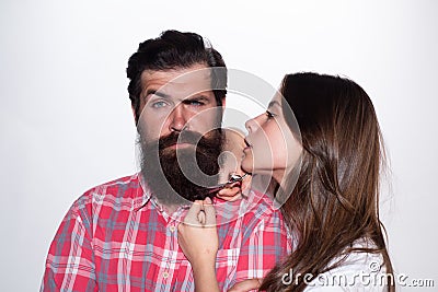 Barbershop procedures. Hairdresser concept. Woman hairdresser cuts beard with scissors. Man with long beard, mustache Stock Photo