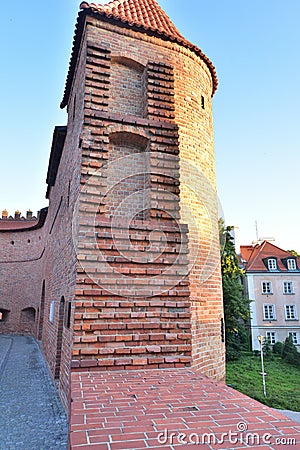 The Barbican Tower in the Warsaw Old Town in the light of the rising sun Stock Photo