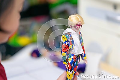 Barbie boy doll in kid hand playing Editorial Stock Photo