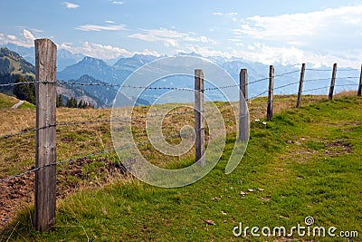 Barbwire fence in the Swiss countryside Stock Photo