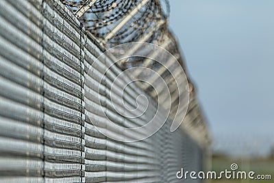 Barbwired fence suggesting illegal immigration Stock Photo