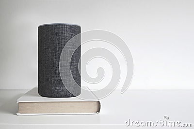 BARCELONA - JANUARY 2019: Amazon Alexa Smart speaker on a book on a shelf Editorial Stock Photo