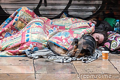 BARCELONA, SPAIN, February 4, 2018 A young homeless guy, a girl Editorial Stock Photo