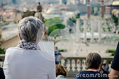 BARCELONA, SPAIN - MAY 18, 2018. Elderly woman artist paints on a street of Barcelona Editorial Stock Photo