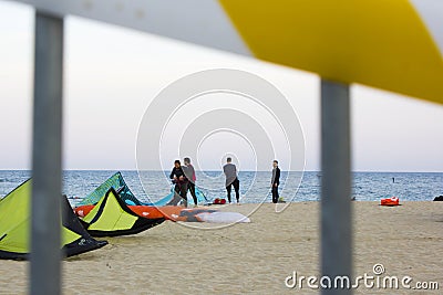 Barcelona, Spain, May 23 2020: view through the closed beach fence on shore and kitesurfers on the Mar bella Barcelona beach. Editorial Stock Photo