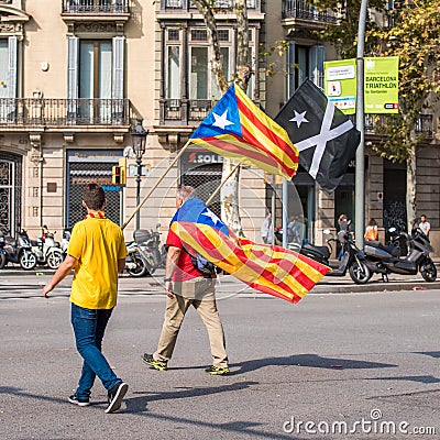 BARCELONA, SPAIN - OCTOBER 3, 2017: Demonstrators bearing catalan flag during protests for independence in Barcelona. Editorial Stock Photo