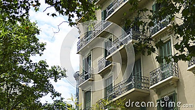Old building in barcelona ornated balconies and trees Editorial Stock Photo