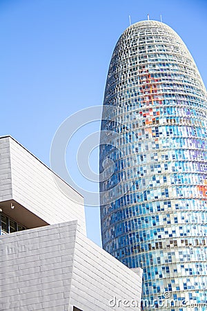 Barcelona Torre Agbar tower in daytime iconic modern designed skyscraper - tall building Editorial Stock Photo