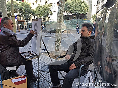 BARCELONA, 28th December- Street artist draw portrait of man Editorial Stock Photo