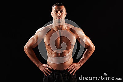 Bare chested male body builder with hands on hips Stock Photo