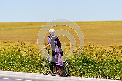 Bare feet Amish Girl Uses Bicycle Scooter Editorial Stock Photo