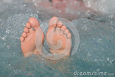 Bare feet out of bubbling water Stock Photo