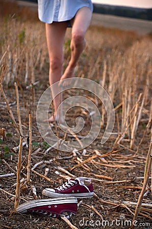 Bare feet, sneakers and girl Stock Photo