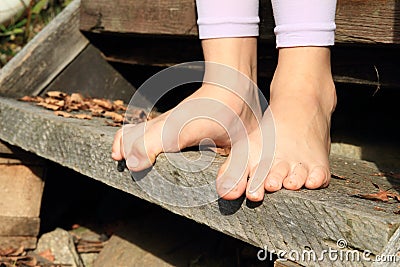 Bare feet on stair Stock Photo