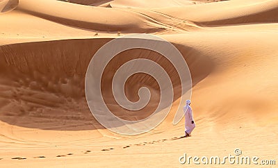 Barefoot Bedouin Walking in Desert of Sharjah Stock Photo