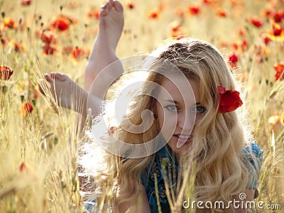 Barefoot blonde in poppies Stock Photo