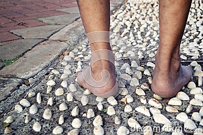 Barefoot at cement stone track for massage the soles of the feet from back Stock Photo