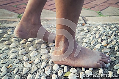 Barefoot at cement stone track for massage the soles of the feet from side Stock Photo