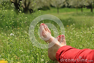 Barefoot female feet on green field Stock Photo