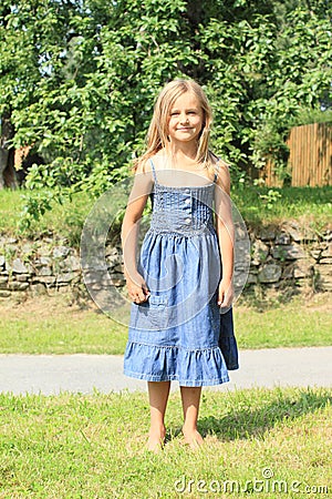 Barefoot girl in blue dress Stock Photo