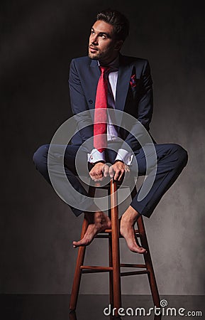 Barefoot Pensive business man looking up Stock Photo