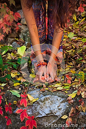 Barefoot woman legs and hands in yoga stretch pose in colorful Stock Photo