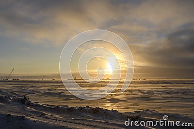 Barge with crane. Dredger working at sea. Sunset in Arctic sea. Construction Marine offshore works. Dam building, crane, barge, Stock Photo