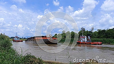 The barge docks at the jetty to load palm oil Editorial Stock Photo