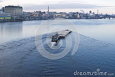 The barge floating in the Dnieper river. Kyiv city landscape in the background. 17.11.2018 Editorial Stock Photo