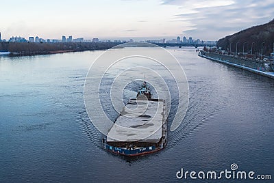 The barge floating in the Dnieper river. Kyiv city landscape in the background. 17.11.2018 Editorial Stock Photo