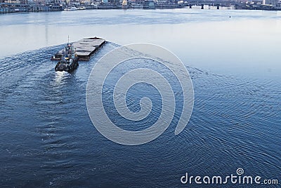 The barge floating in the Dnieper river. Kyiv city landscape in the background. 17.11.2018 Editorial Stock Photo