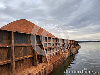 barge loaded with bauxite from Kalimantan Indonesia Stock Photo