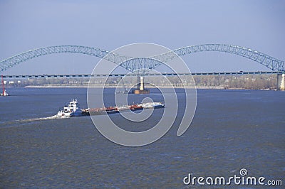Barge on Mississippi River with Bridge and Memphis, TN in background Editorial Stock Photo