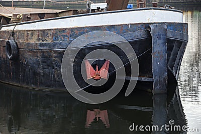 Barge with red anchor Stock Photo