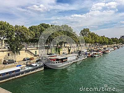 Barges and houseboats along the Right Bank of the Seine River, Paris France Editorial Stock Photo