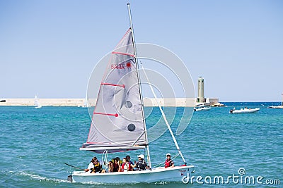 BARI, ITALY - JULY 11,2018, the guys are sailing in the port of Bari on a sunny summer day, sailing school Editorial Stock Photo