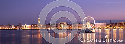 Bari, Italy at night. Illuminated giant Ferris wheel Stock Photo