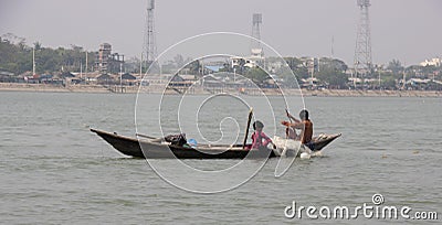 Barisal, Bangladesh, March 12, 2023, Rural fishermen on a small wooden boat. Kids catching fish on a small dinghy floating on a Editorial Stock Photo