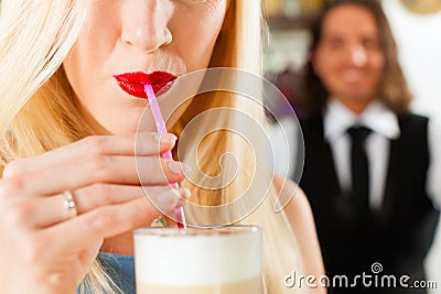Barista with client in his cafe or coffeeshop Stock Photo