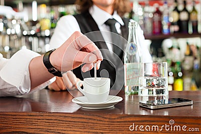 Barista with client in his cafe or coffeeshop Stock Photo