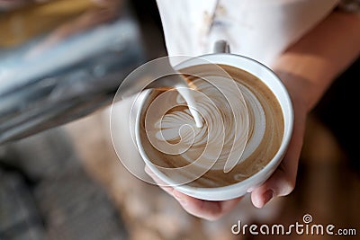 Barista creating latte art coffee. Stock Photo