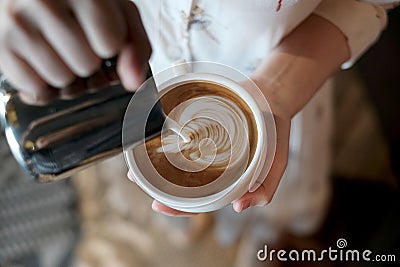 Barista creating latte art coffee. Stock Photo