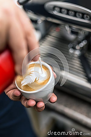 Barista creating latte art Stock Photo