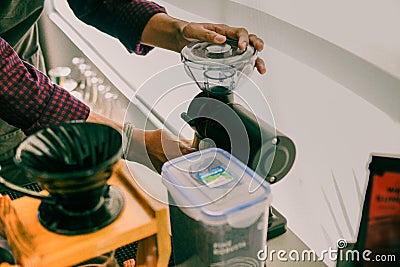 Barista grinding coffee beans Stock Photo