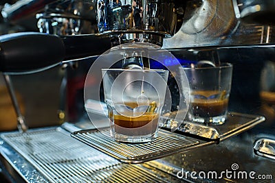 Barista makes fresh and tasty coffee on a coffee machine Stock Photo