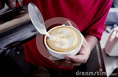 Barista making latte or Cappuccino art with frothy foam, coffee Stock Photo