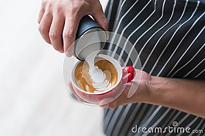 Barista making latte or cappuccino coffee pouring milk Stock Photo