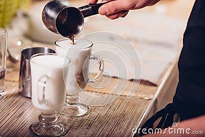 Barista making latte , hands and cups in the picture Stock Photo