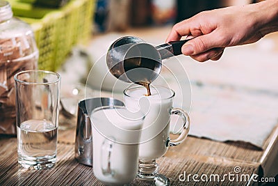 Barista making latte , hands and cups in the picture Stock Photo