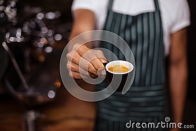 Barista offering an espresso Stock Photo